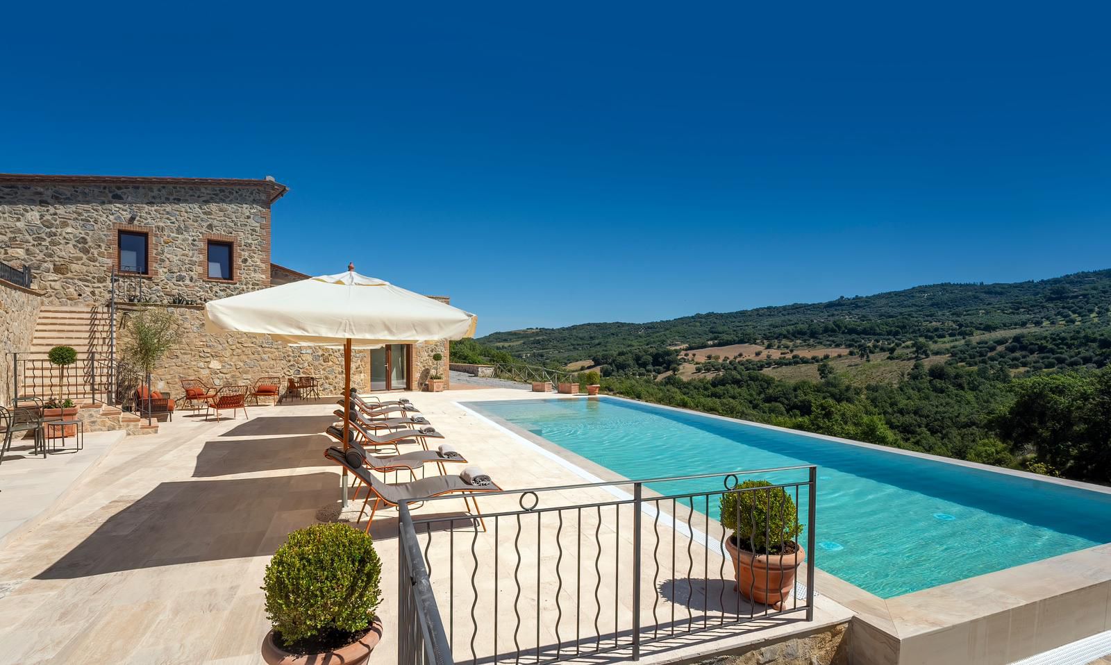A private villa terrace in Tuscany with a pool overlooking olive hills