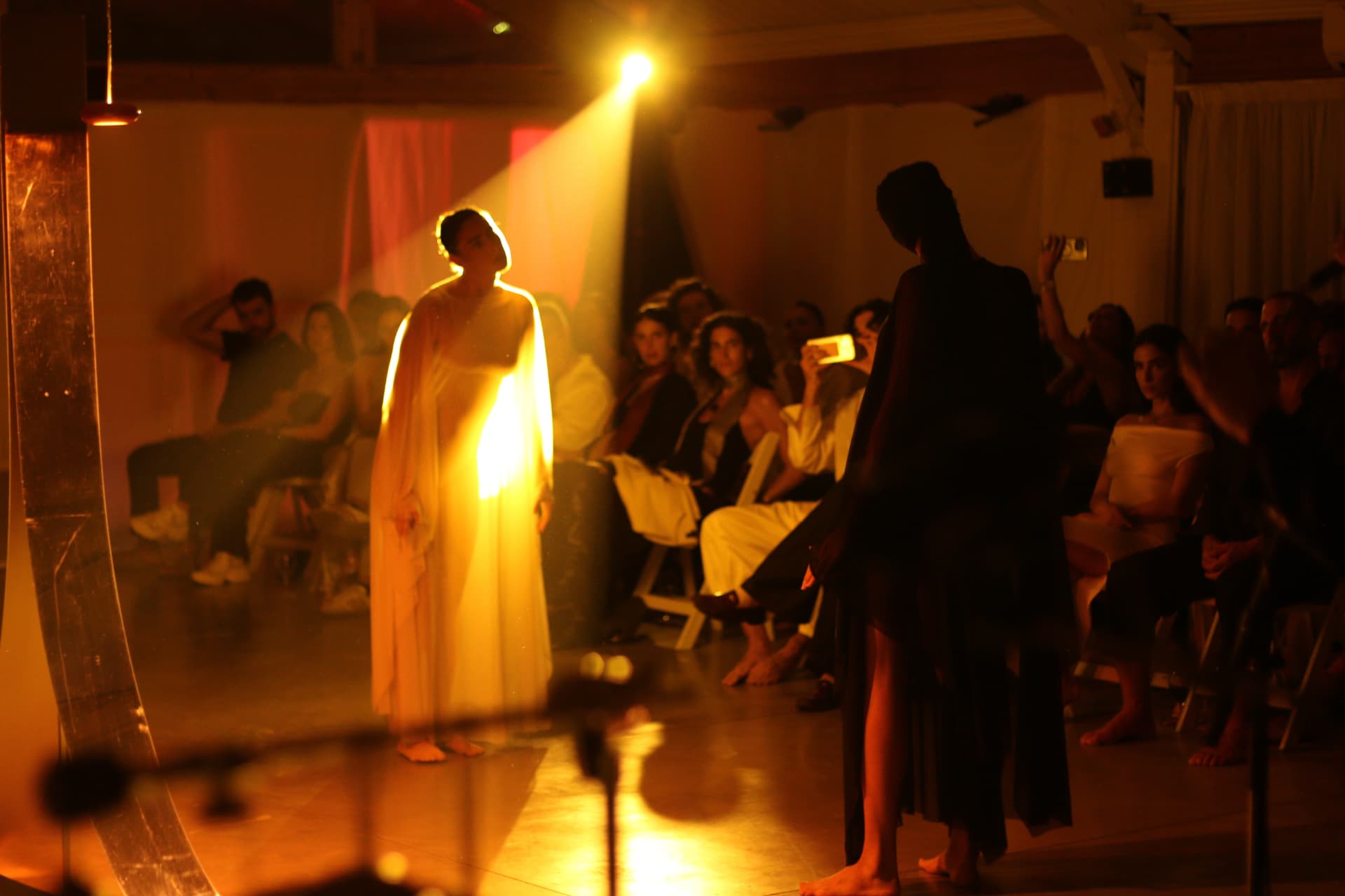 Goni setting up singing bowls and candles in a softly lit room
