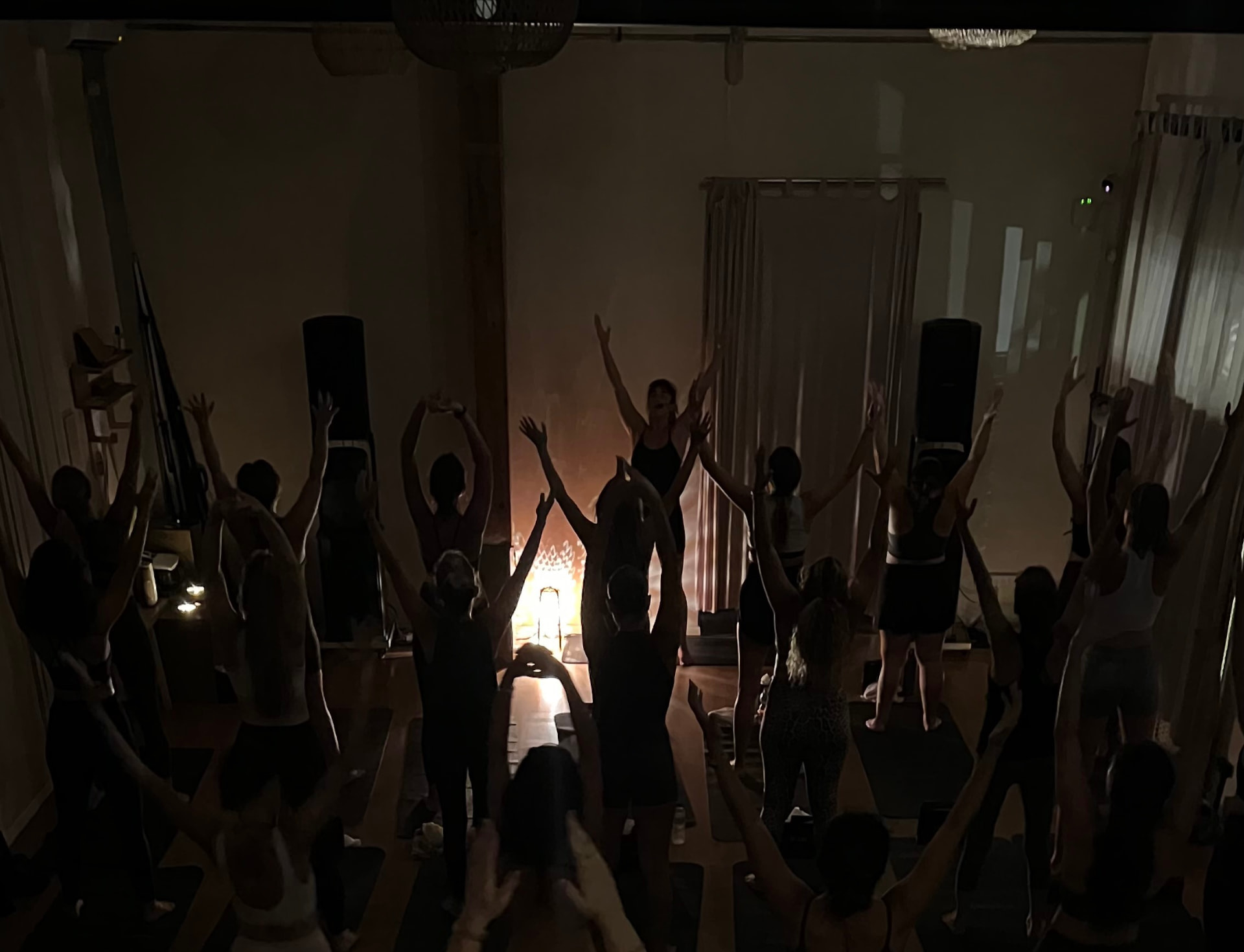 Goni setting up singing bowls and candles in a softly lit room